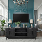 Radiance TV Stand 85 inch TVs - Black Finish placed in a teal-accented room with mounted TV, plants, and modern decor.