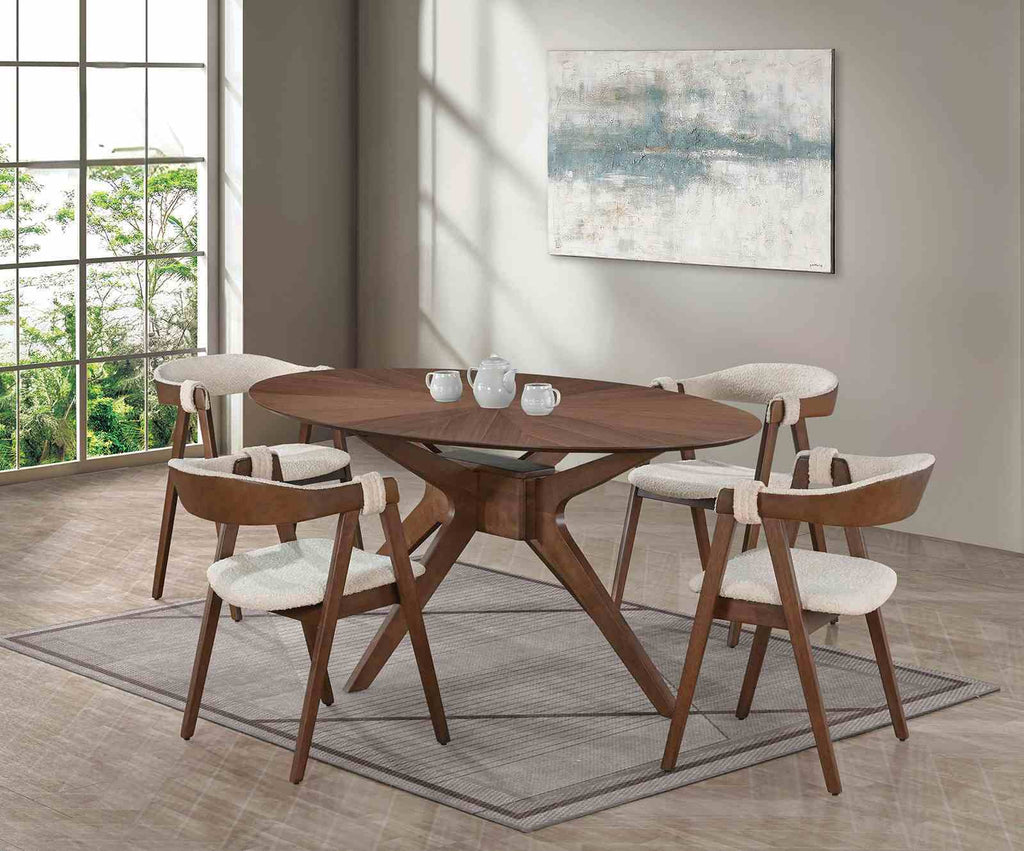 Dining room setup featuring four Walnut & Beige Mid-Century Modern Side Chairs with boucle seats around a round wooden table.