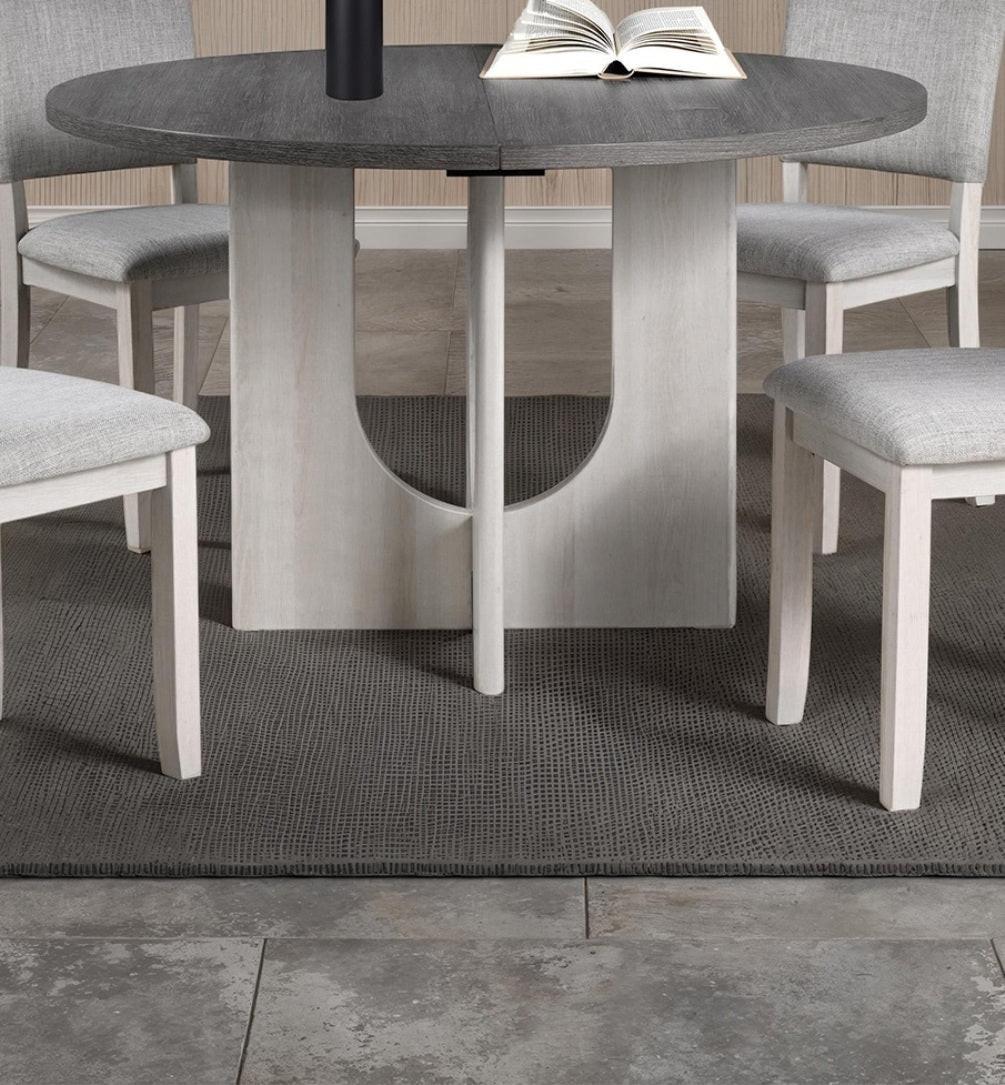 5pc dining set with gray upholstered chairs and round table.