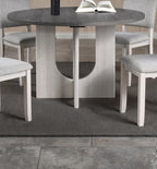 5pc dining set with gray upholstered chairs and round table.
