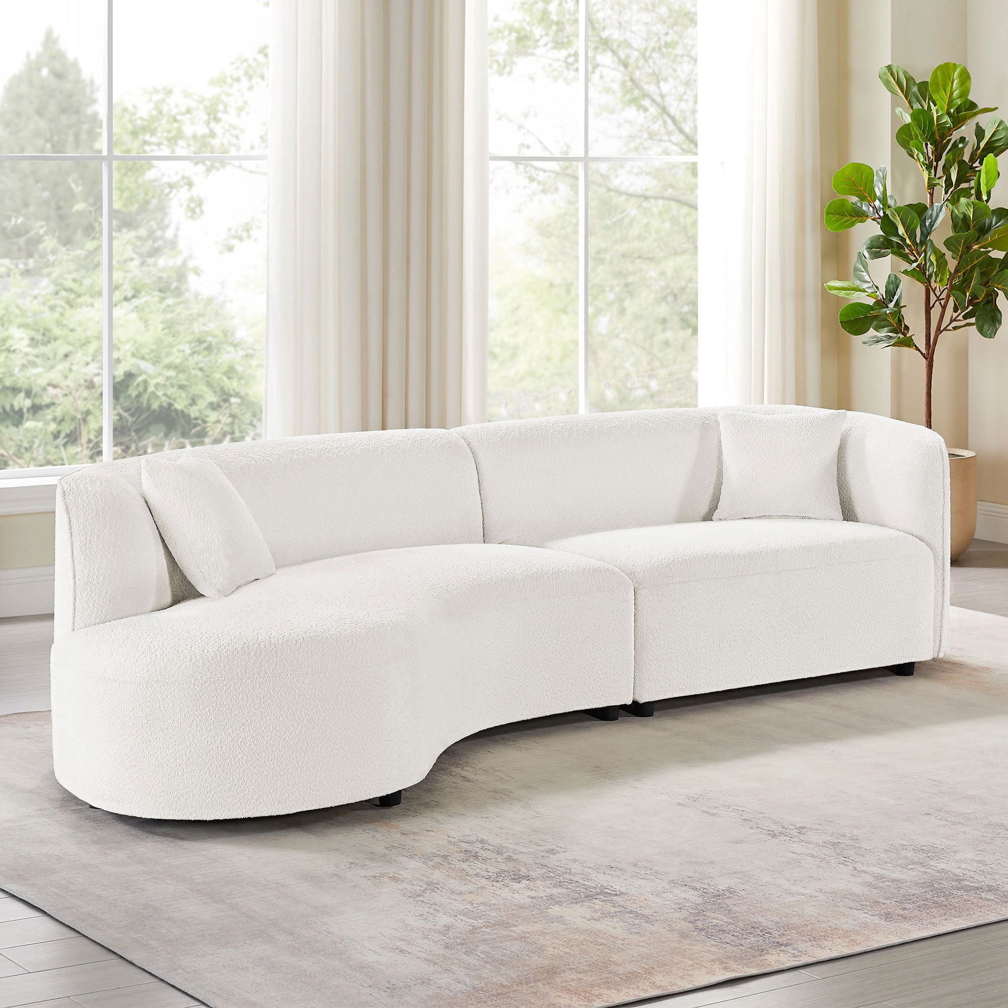 Modern curved sofa set in white bouclé placed in a bright living room, blending luxury and comfort with a solid wood frame.
