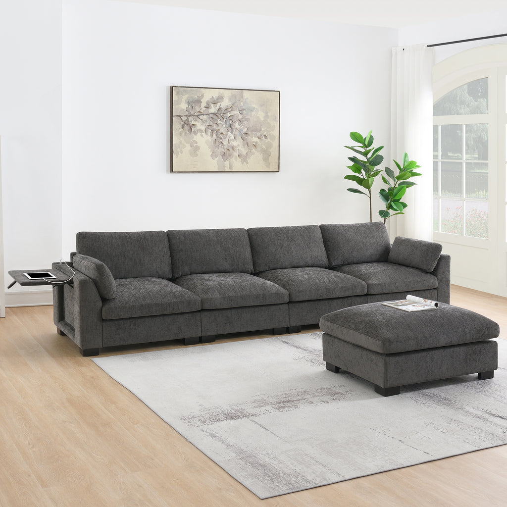 Charcoal gray chenille modular sectional sofa with folding tray, charging port, and a matching ottoman.