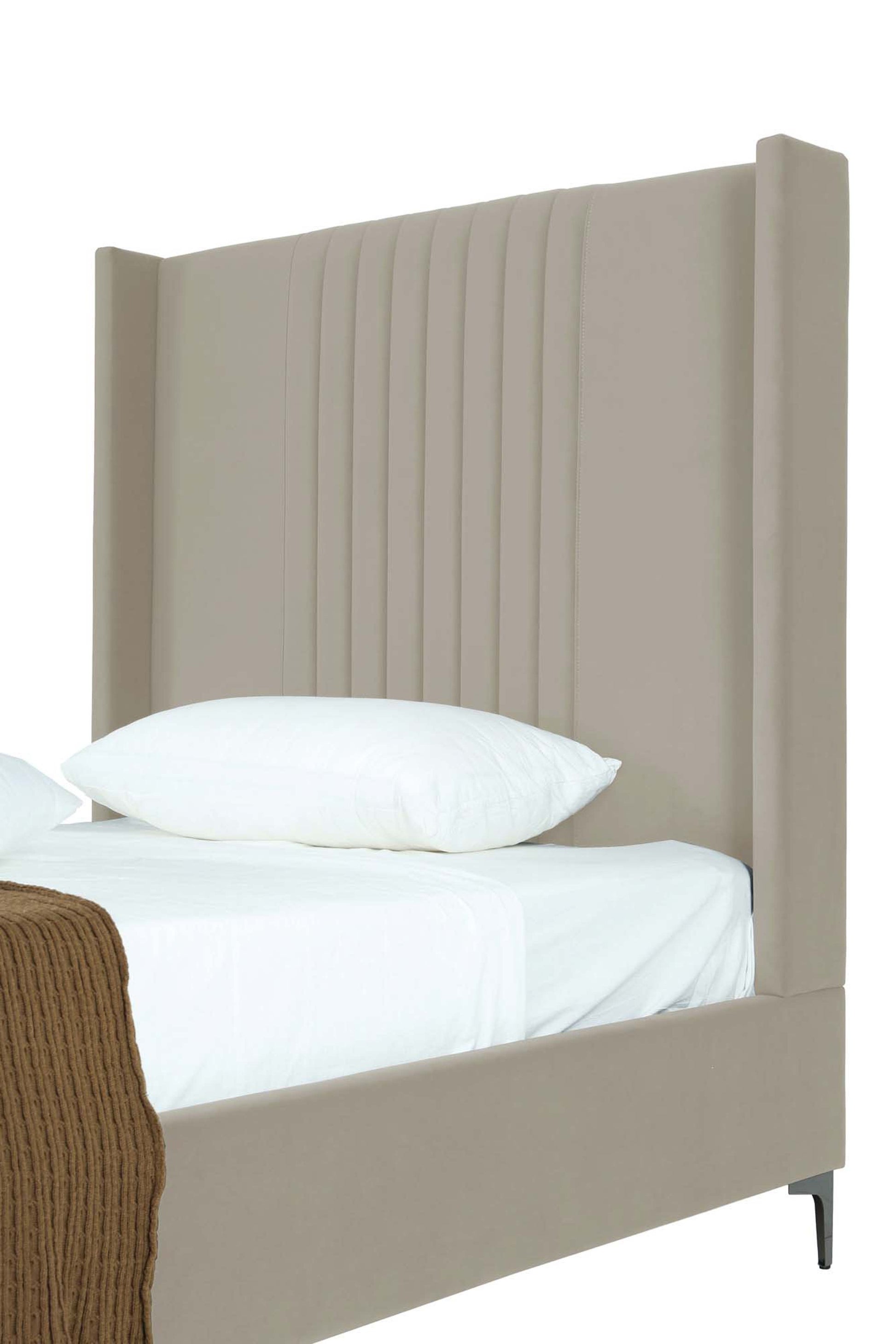 Close-up side angle of Promenade Upholstered Velvet Bed Frame in Rustic Taupe 48' showing vertical channel tufting on headboard.