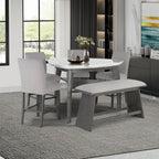 Jasmine Bar Table set in a dining room with grey chairs and bench, featuring a grey marble top and arched legs, seats 4 comfortably.