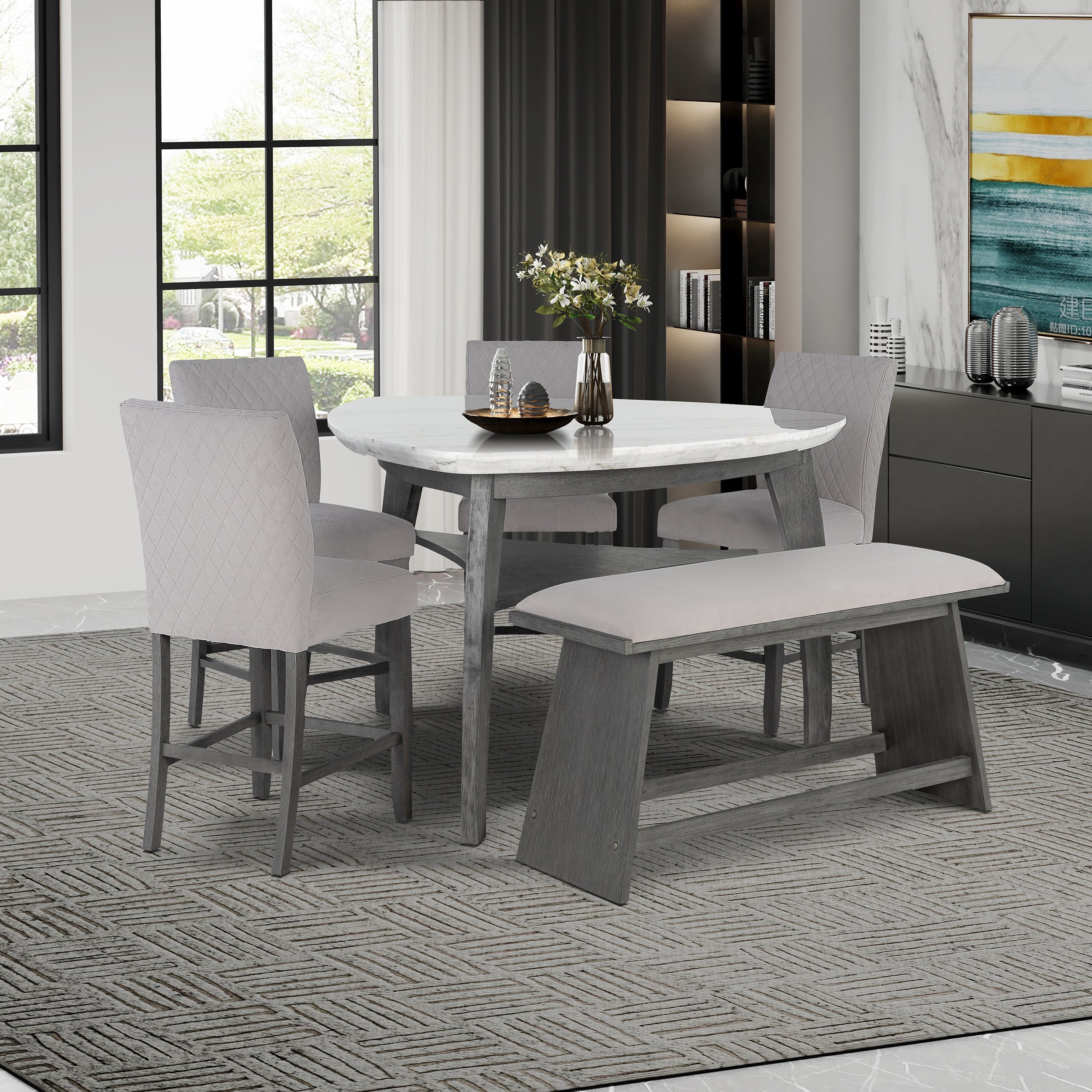 Jasmine Bar Table set in a dining room with grey chairs and bench, featuring a grey marble top and arched legs, seats 4 comfortably.