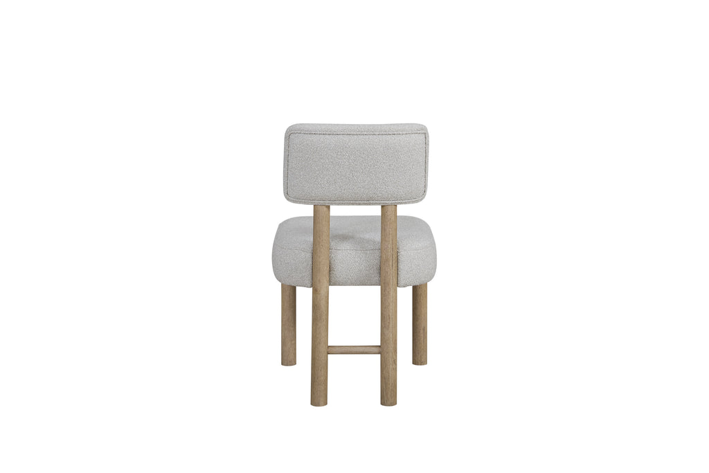 Back view of upholstered dining chair with light gray fabric and oak frame, highlighting clean stitching and durable build.