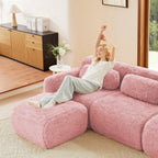 Woman relaxing on pink plush modular sofa with movable ottoman, showcasing its ergonomic comfort and cozy design for living rooms.