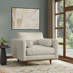 Modern armchair cream white from Morrison Collection in a living room setting with wood legs and bolster pillows. Stylish and cozy for any space.
