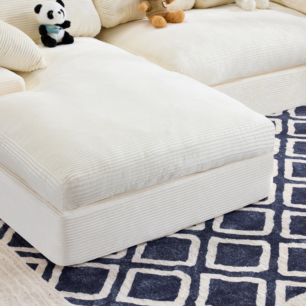 Close-up of chaise section of White Corduroy Sofa with soft ribbed texture and plush cushioning on a navy patterned rug.