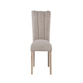 Modern Beige Dining Chair with tufted backrest and rubberwood legs, ideal for contemporary dining room settings.