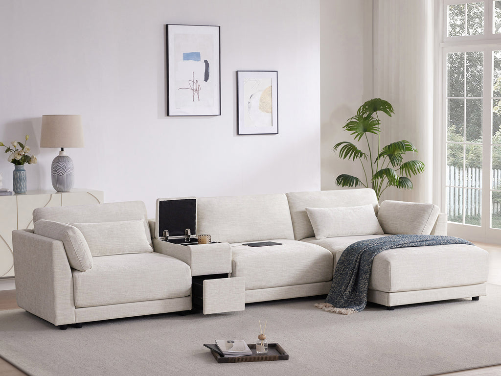 Modern L-Shaped sectional sofa with storage and charging console, styled with throw blanket and pillows in a sunlit living room.