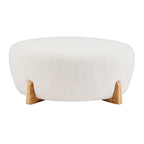 Modish Round Ottoman with Boucle Top and Natural Wood Legs.