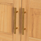 Close-up of gold metal handles on arched kitchen pantry cabinet doors, adding a modern touch to kitchen storage furniture.