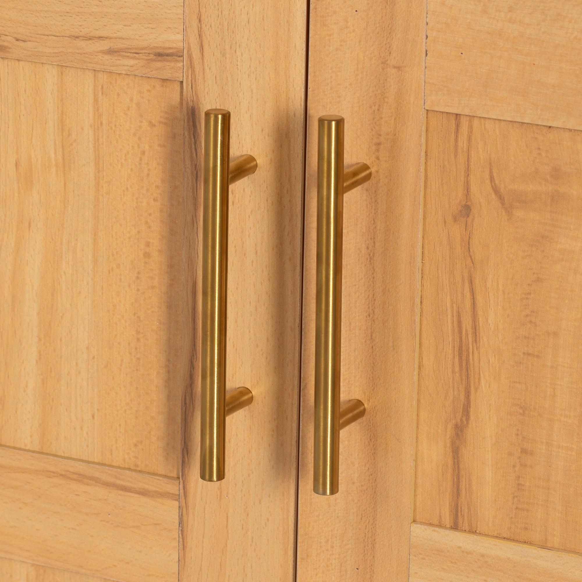 Close-up of gold metal handles on arched kitchen pantry cabinet doors, adding a modern touch to kitchen storage furniture.