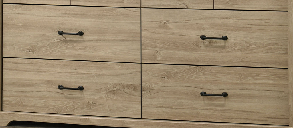 Lower drawers of Elara Light Oak Dresser featuring black metal handles and natural oak wood grain texture.