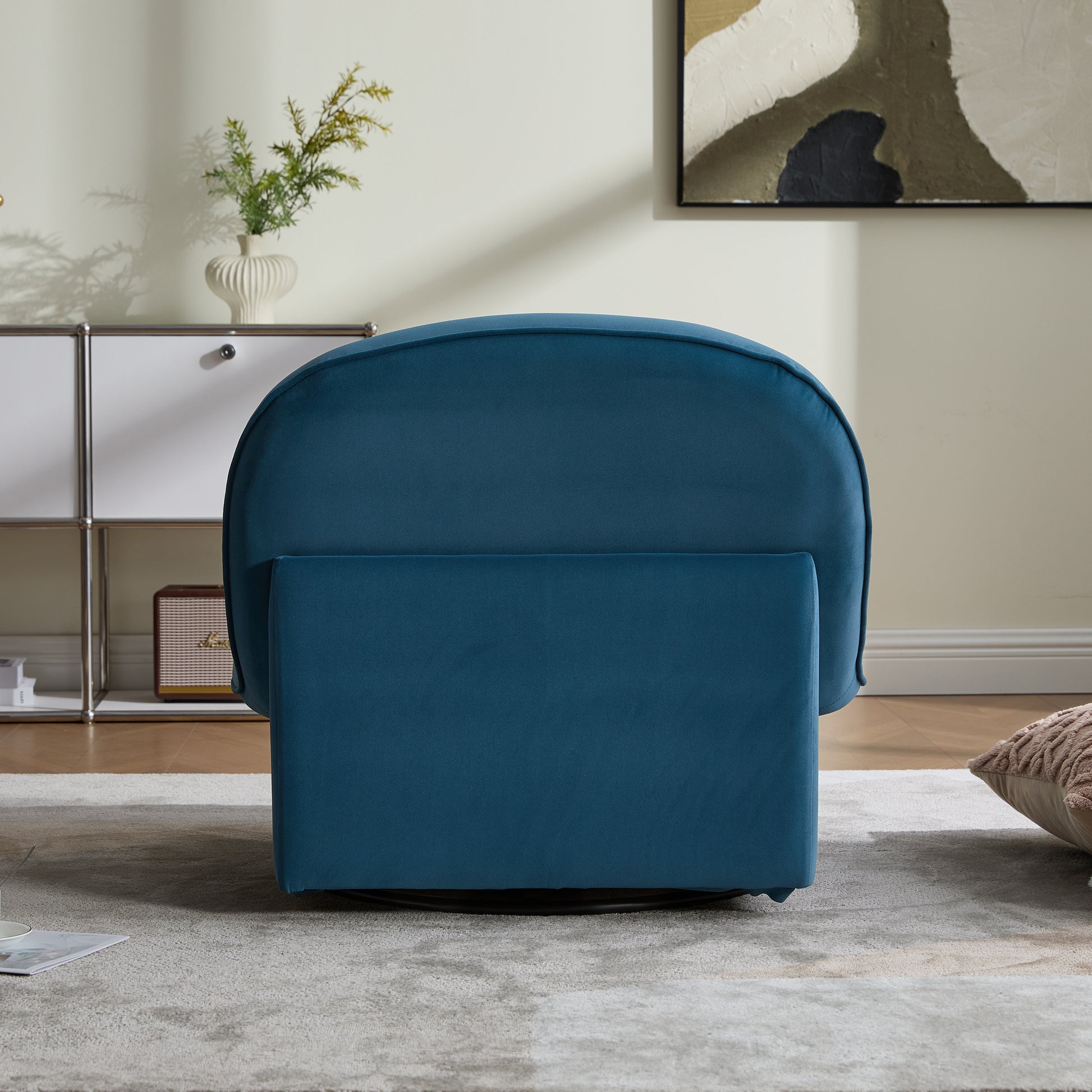 Rear view of pumpkin-shaped swivel accent chair in teal velvet, showcasing its plush backrest and compact design.