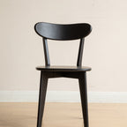 Front view of Solid Oak Dining Chair in black, featuring a contoured seat and supportive backrest for dining comfort.