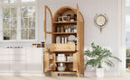 Arched kitchen pantry cabinet styled in a kitchen setting, filled with pantry items and cookware for organized storage.