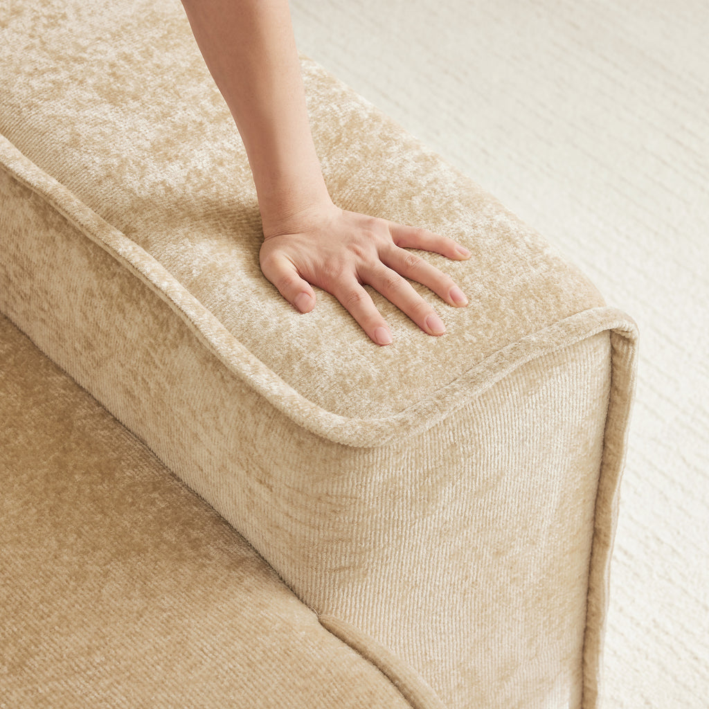 Hand pressing into armrest of Modular Velvet Sectional Sofa, showing soft, cloud-like cushioning. No assembly required for easy setup.