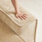 Hand pressing into armrest of Modular Velvet Sectional Sofa, showing soft, cloud-like cushioning. No assembly required for easy setup.