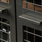 Close-up of metal handle on mesh door of Industrial Brown TV Credenza, emphasizing industrial design and easy access.