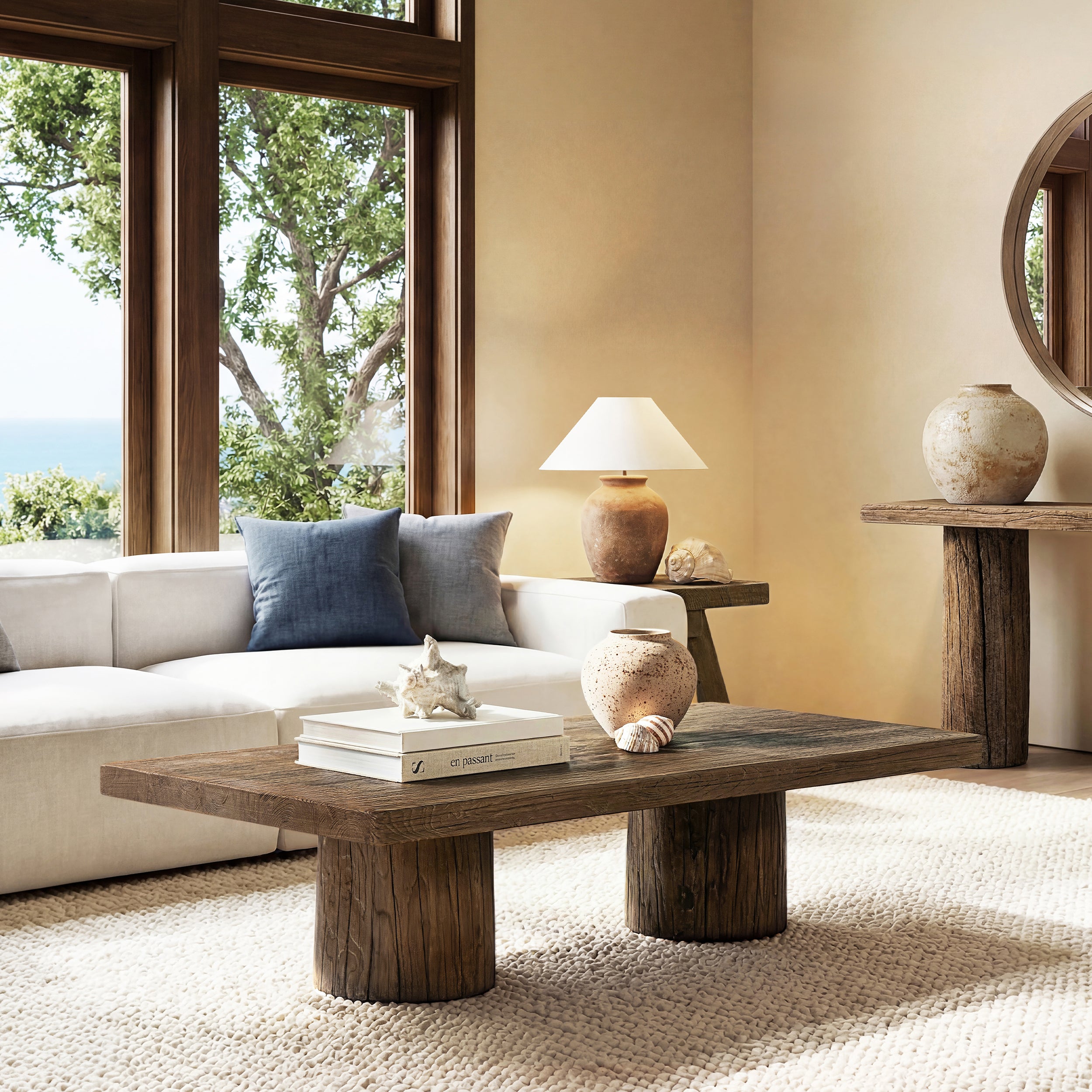 Arbor rectangular coffee table in medium-dark brown reclaimed elm with rustic, chunky plinth-style cylindrical legs.