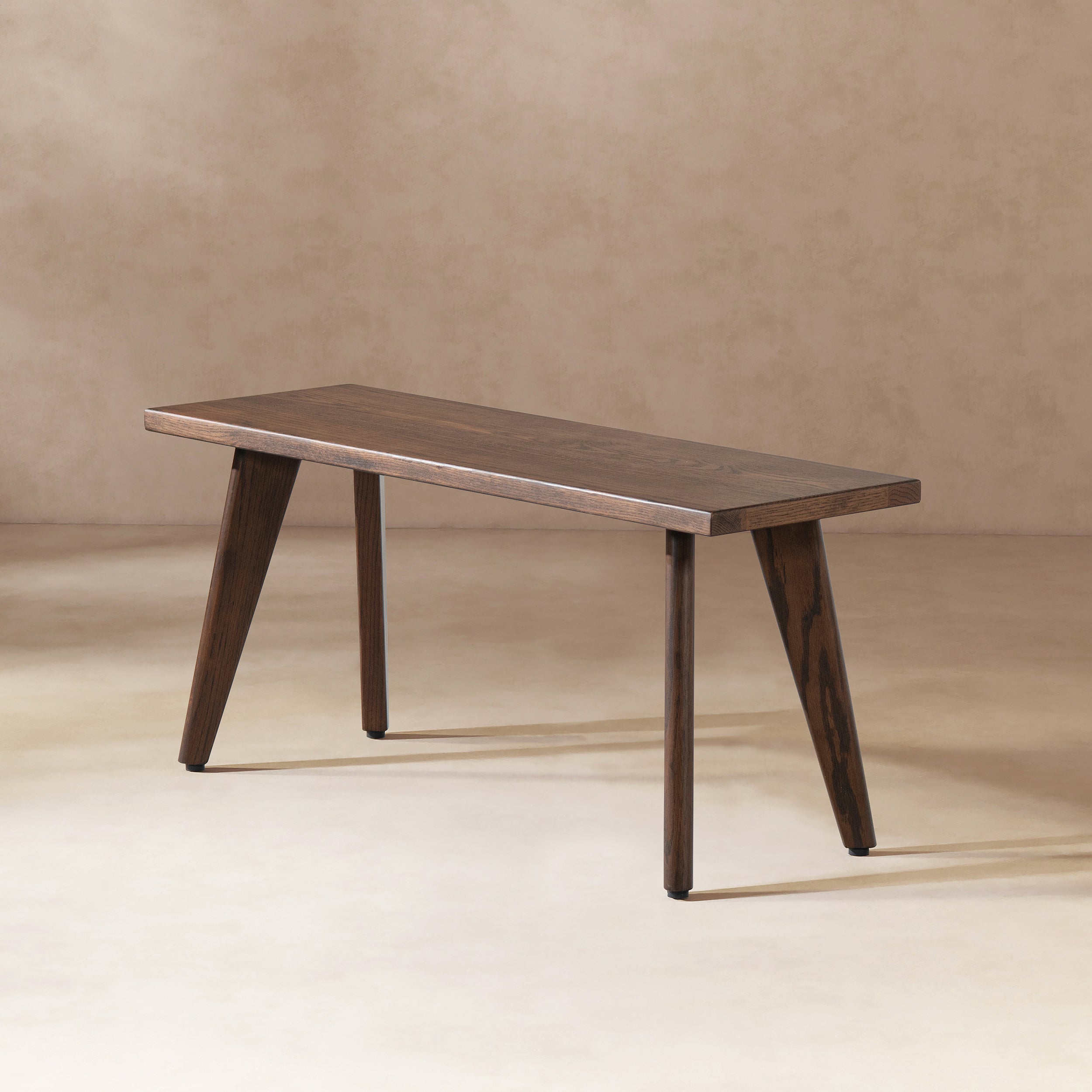 Dark brown Capri 41.5' solid red oak wood bench shown in neutral setting. Sleek profile complements entryways or dining areas.