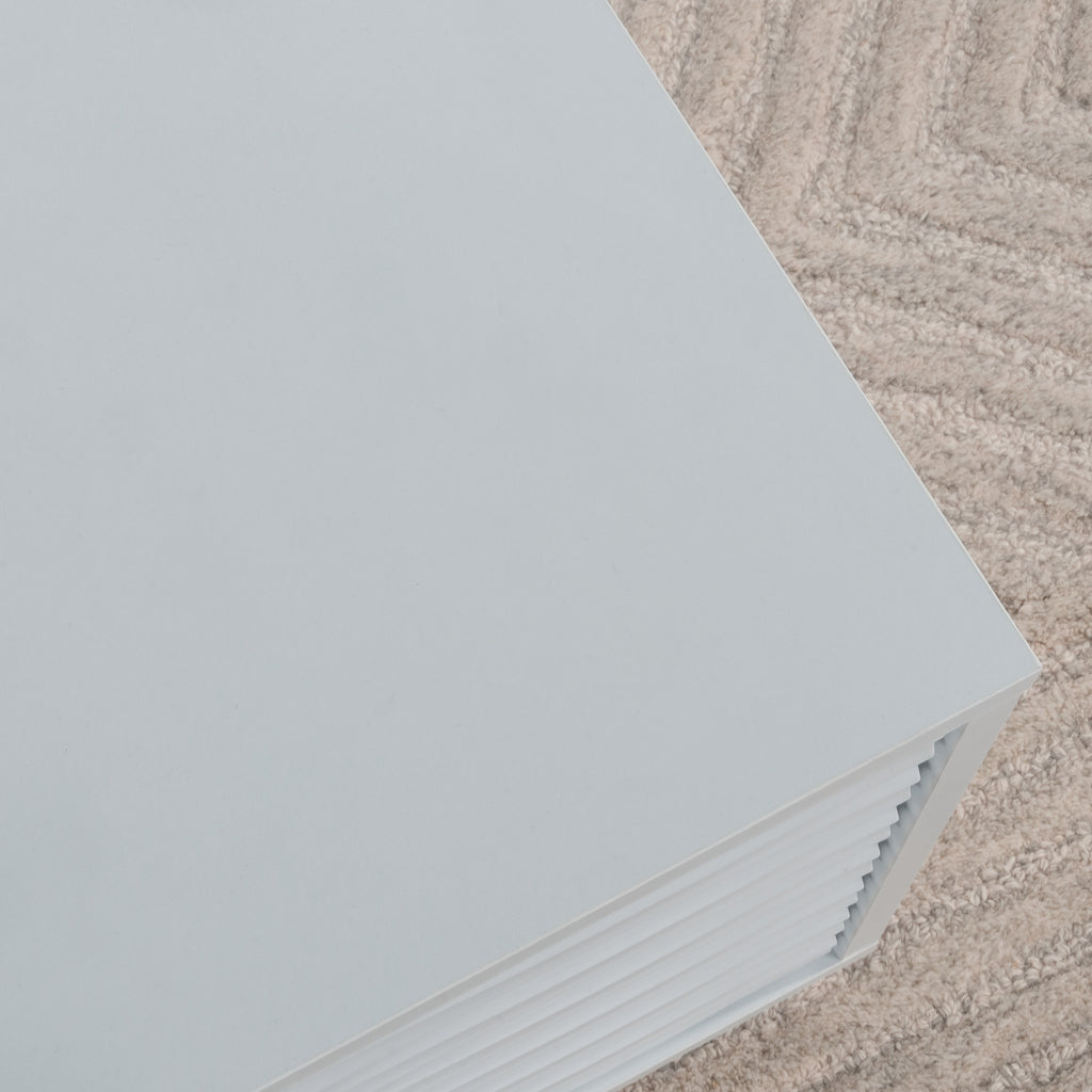 Minimalist top corner of the white coffee table showing clean lines and smooth white finish, ideal for modern interiors.