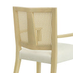Detailed view of woven rattan backrest on modern dining chair, paired with light wood frame and soft upholstered seat.