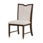Angled view of transitional dining chair with soft upholstered seat, cherry wood frame, and gold-capped legs for elegant dining decor.