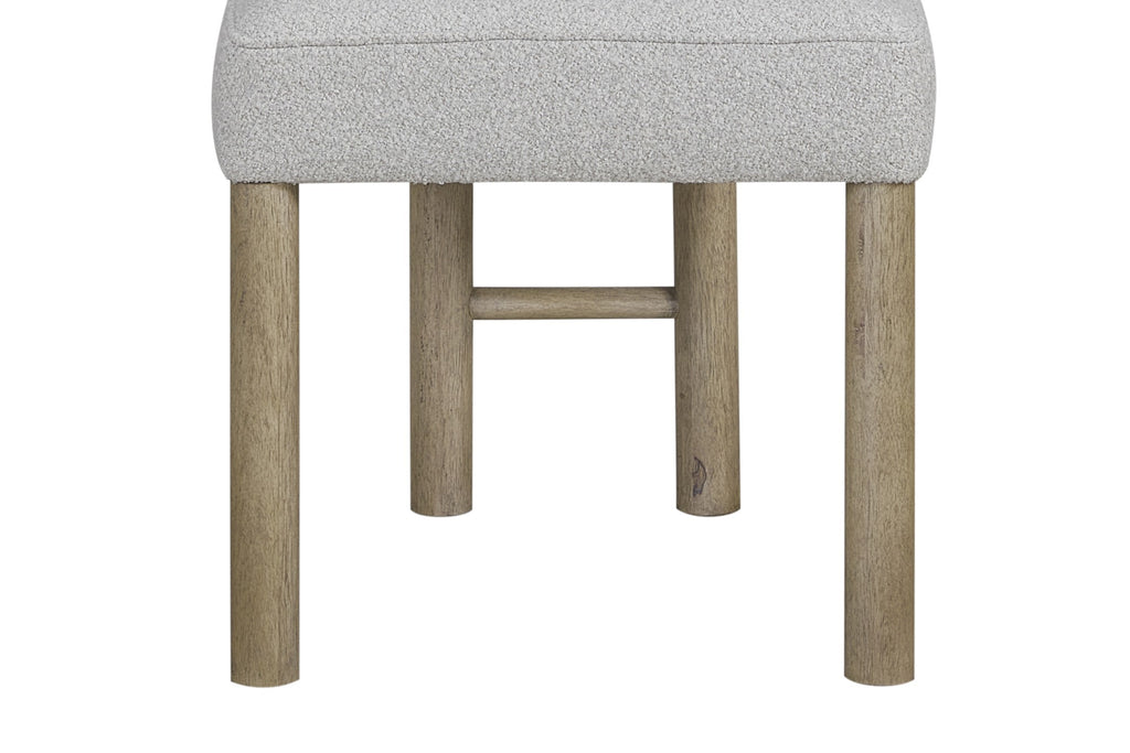 Close-up of oak wood legs and support bar of upholstered dining chair, showcasing sturdy construction and natural finish.