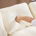 Close-up of hand pressing into soft white corduroy back cushion, highlighting the plush and skin-friendly texture of the compressed corduroy sofa.