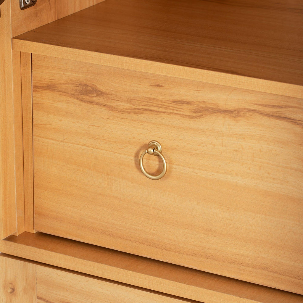 Close-up of central drawer with gold ring pull on arched kitchen pantry cabinet, ideal for storing utensils or linens.