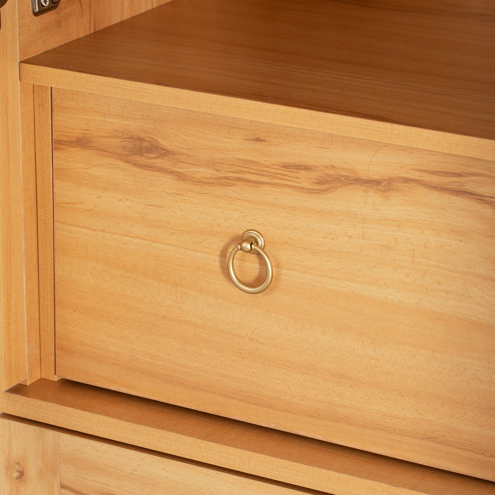 Close-up of central drawer with gold ring pull on arched kitchen pantry cabinet, ideal for storing utensils or linens.