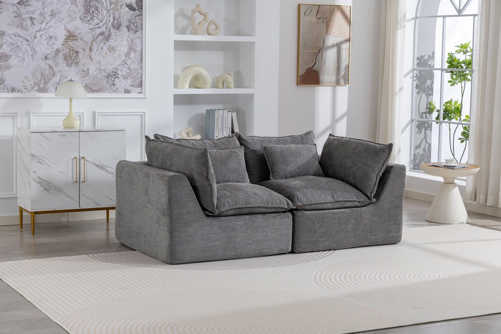Oversized modular sectional couch in antique grey velvet with plush cushions, styled in a modern living room with natural light and decor.
