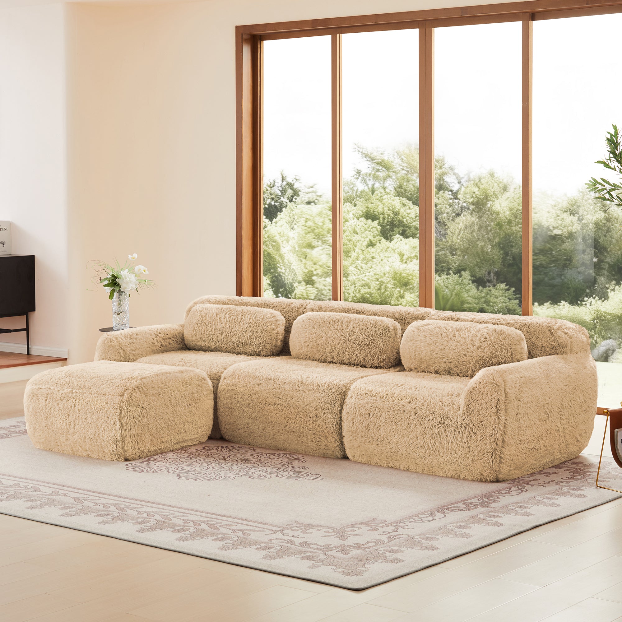 Modular sectional sofa in plush beige fabric with ottoman, showcasing flexible configuration and cozy seating.