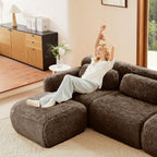 Woman stretching on chocolate modular sofa 3-seater plush fabric with movable ottoman, showing comfort and spaciousness.