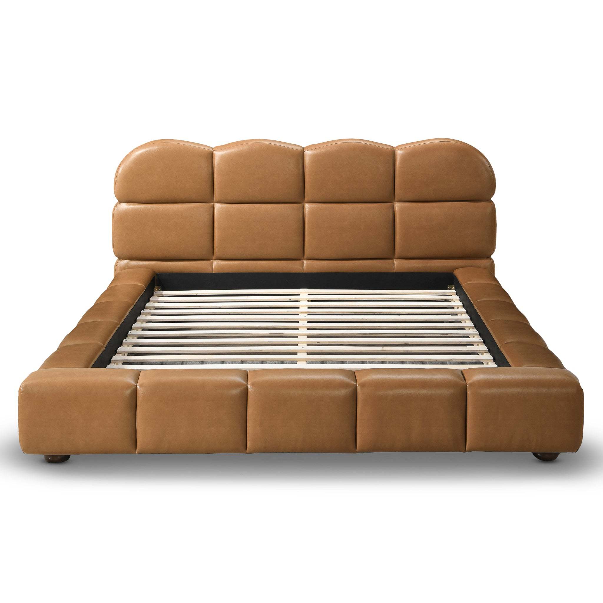 Tan vegan leather queen platform bed with a biscuit-tufted headboard and matching upholstered frame with wooden slats.