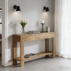 Rustic oak console table featuring three storage drawers, a lower display shelf, and sturdy block legs in a home entryway.