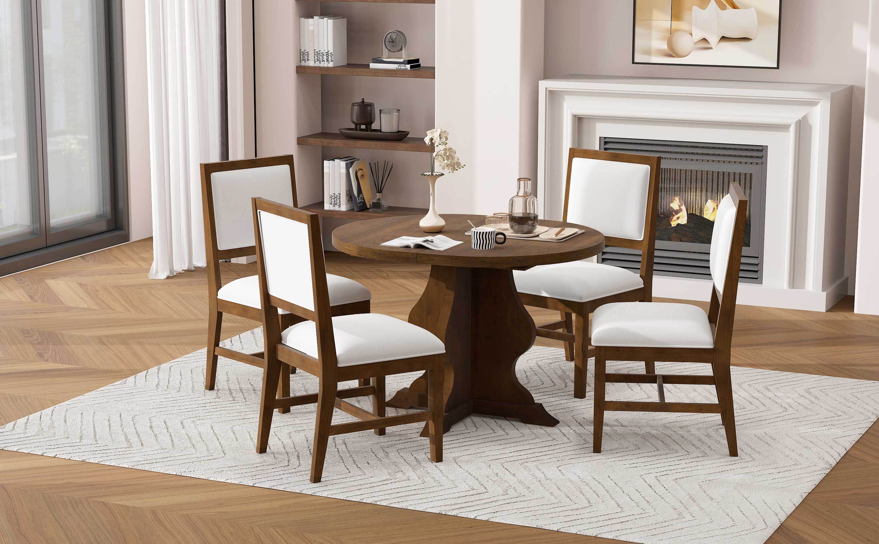 Round farmhouse dining table set with four upholstered chairs in a modern rustic room. Great for small to medium dining spaces.