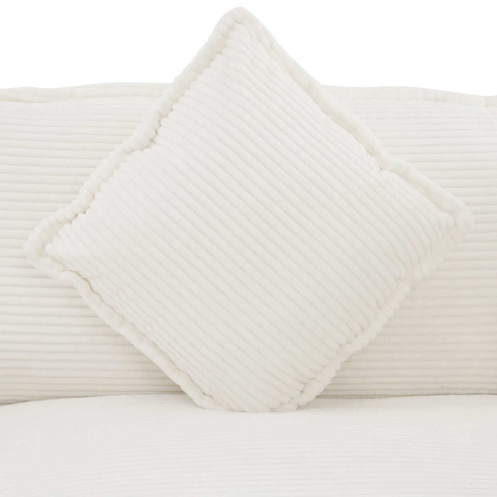 Square pillow detail from Modular Corduroy Sofa Beige - Stylish and Comfortable, featuring plush corduroy fabric and piped edges.